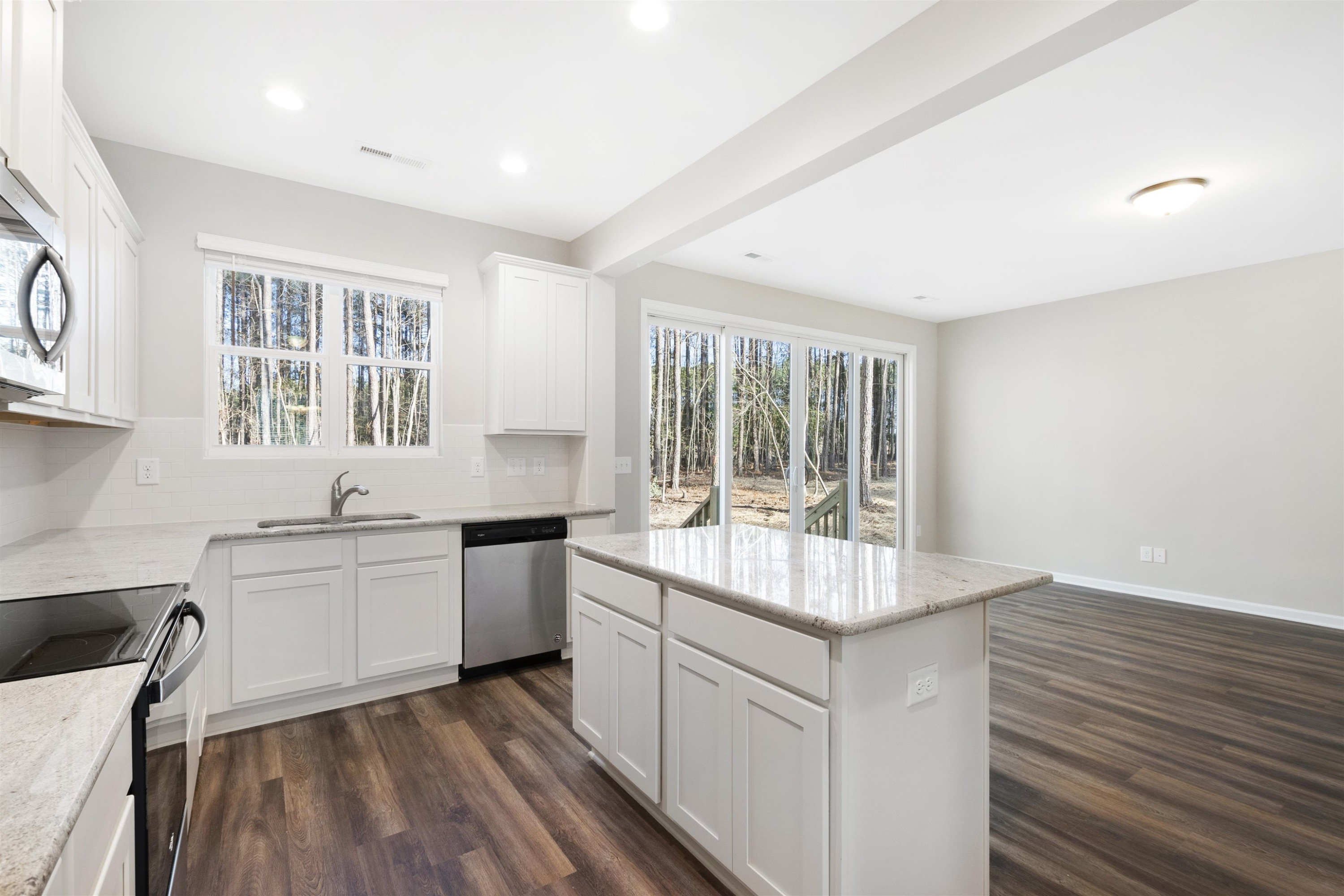 372 Nickleby Way Wendell, NC 27591 - Photo 15 of 37 a kitchen with a sink stove and cabinets