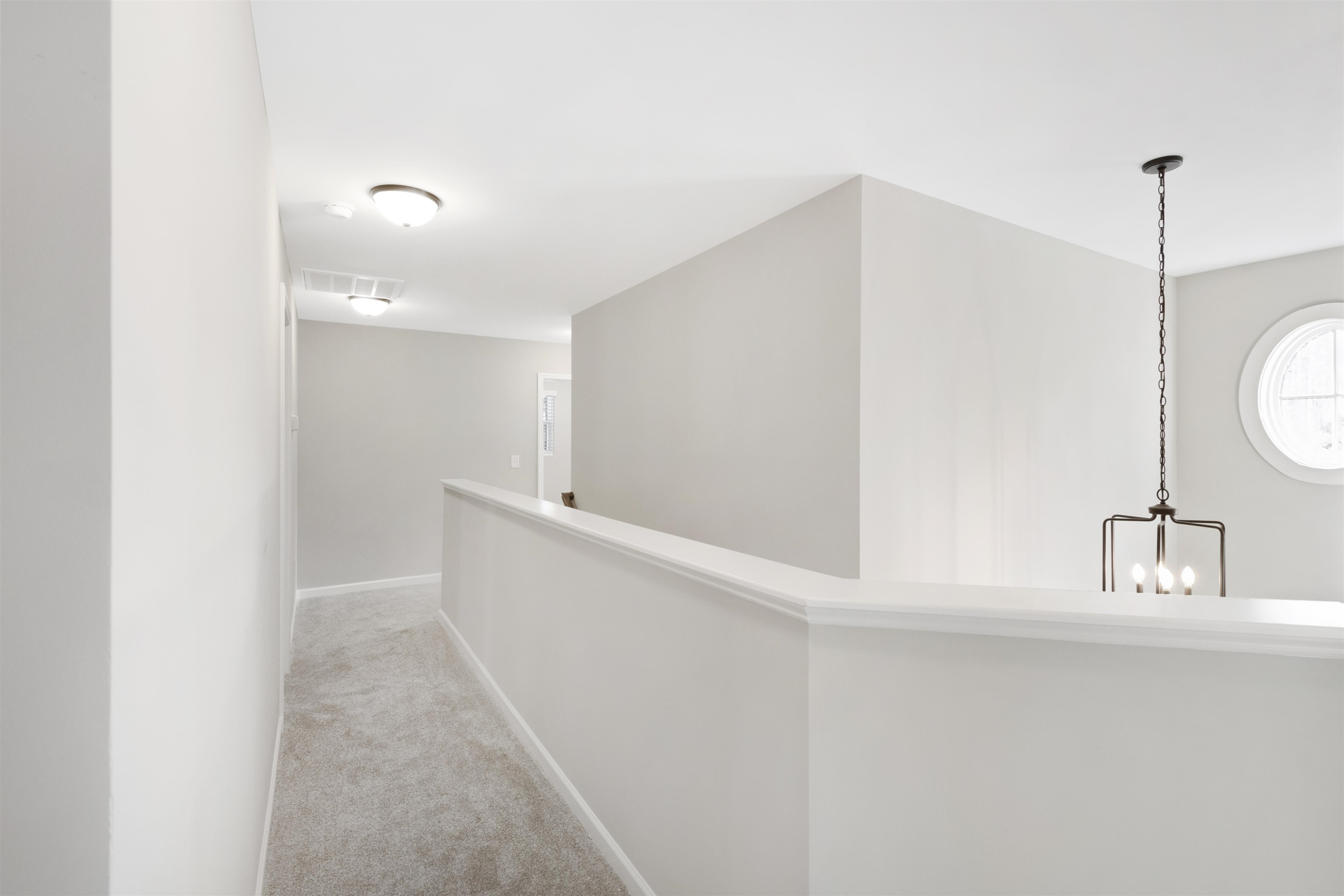 372 Nickleby Way Wendell, NC 27591 - Photo 17 of 37 a view of a hallway to a room with wooden floor