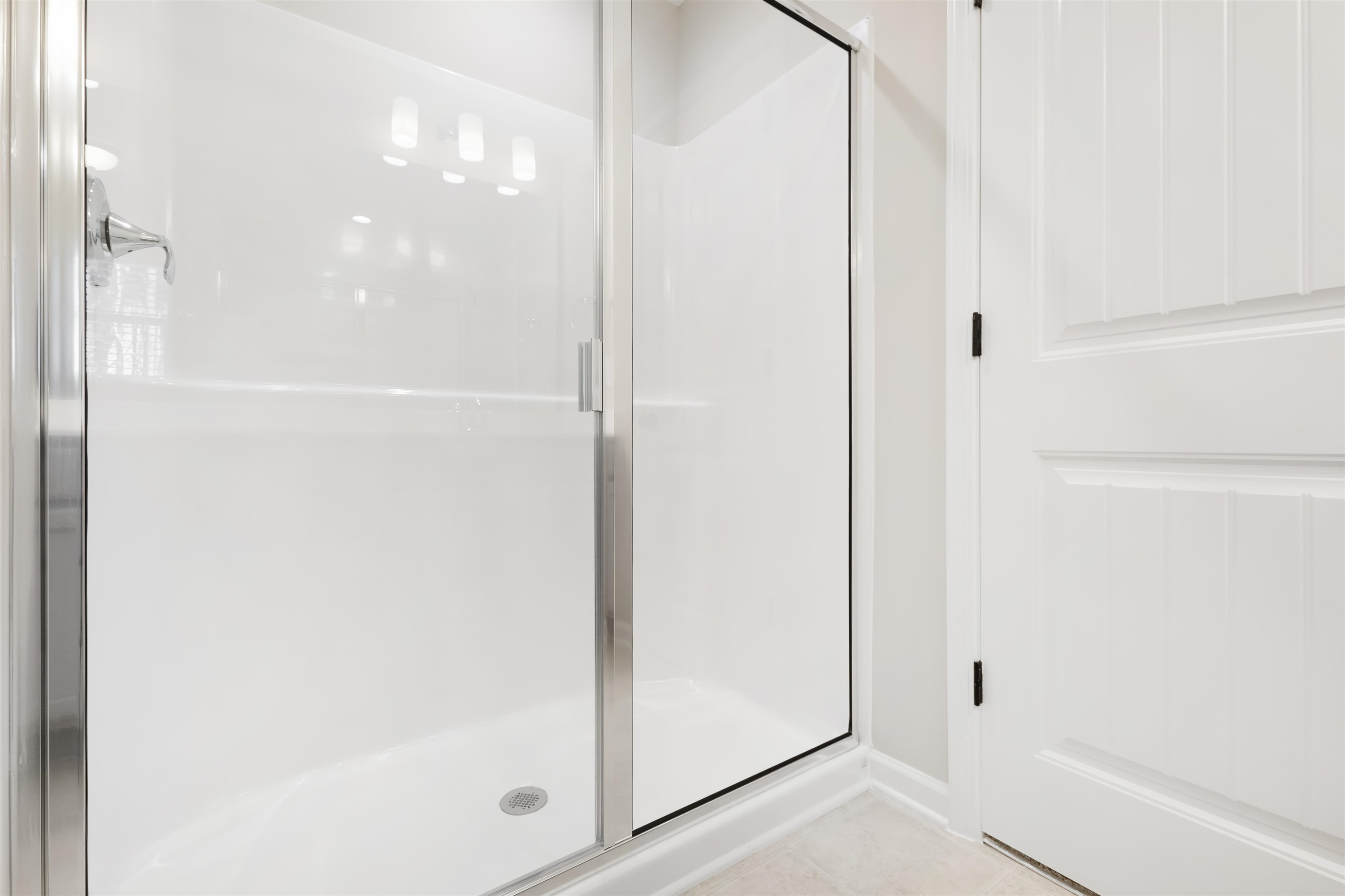 372 Nickleby Way Wendell, NC 27591 - Photo 32 of 37 a bathroom with a glass shower door