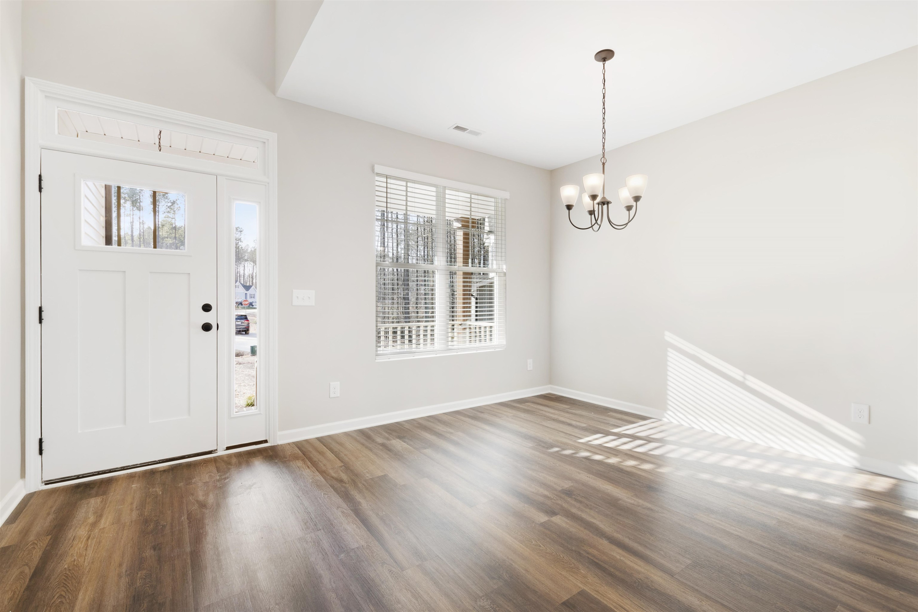 372 Nickleby Way Wendell, NC 27591 - Photo 5 of 37 a view of an empty room with wooden floor and a window