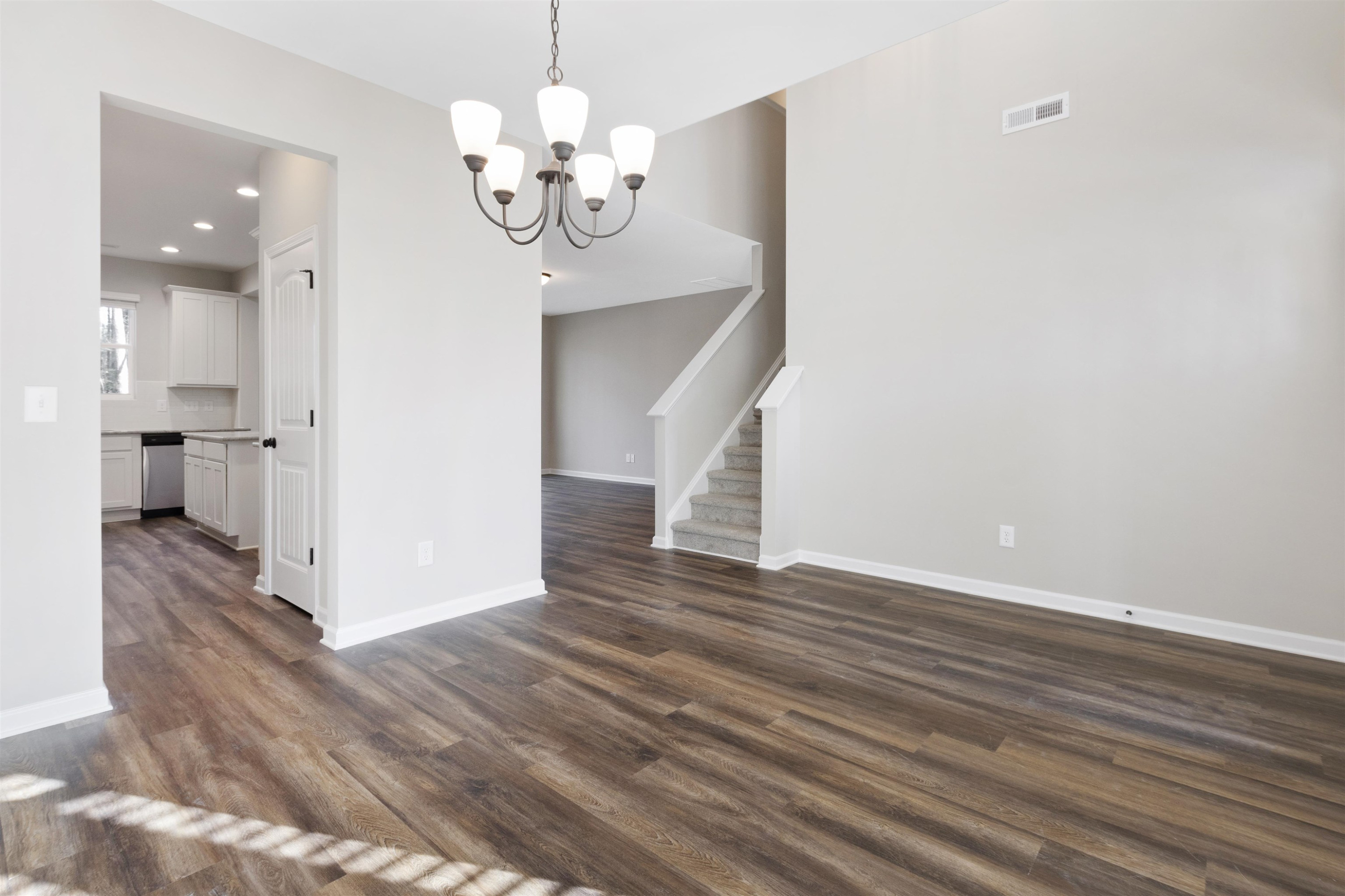 372 Nickleby Way Wendell, NC 27591 - Photo 7 of 37 a view of a chandelier and wooden floor