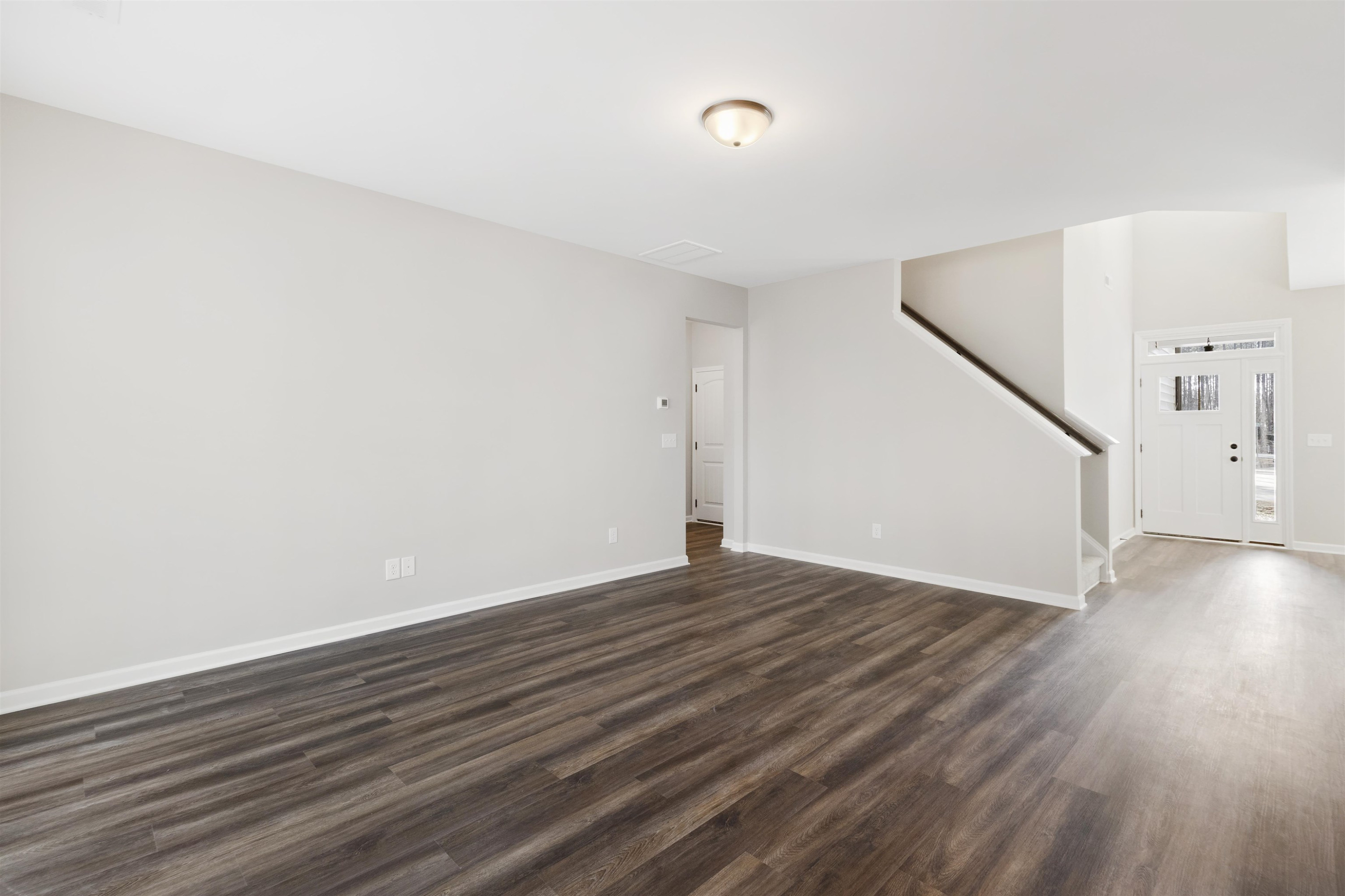 372 Nickleby Way Wendell, NC 27591 - Photo 8 of 37 a view of an empty room with wooden floor and stairs
