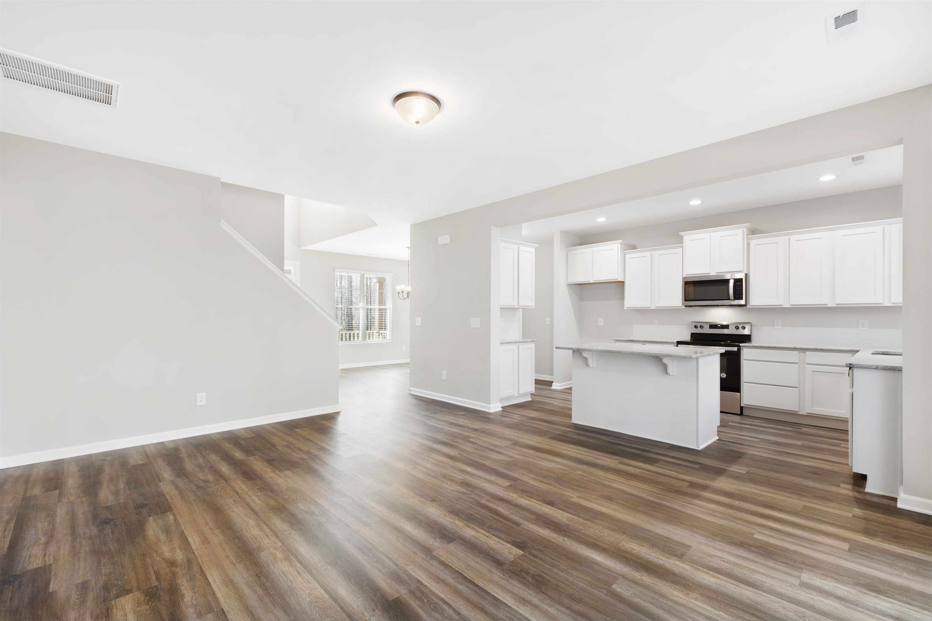 372 Nickleby Way Wendell, NC 27591 - Photo 9 of 37 a view of kitchen with wooden floor and electronic appliances