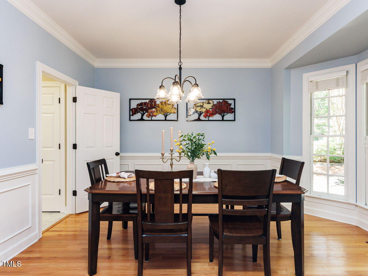 4613 Wee Burn Trail Raleigh, NC 27612 - Photo 12 of 49 Separate open dining area with bay window, crown molding, beautiful glass lighting, and immaculate hardwood flooring.