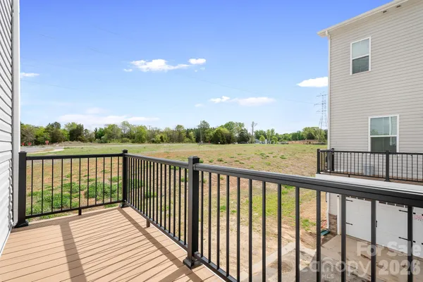 a view of a balcony with wooden fence
