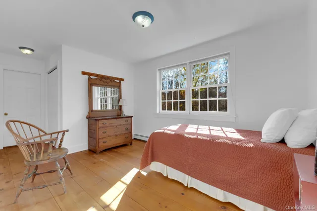 a bedroom with a bed and chair