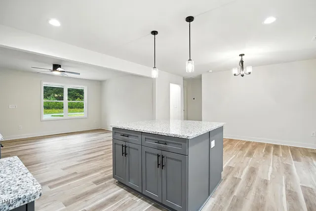 a kitchen with kitchen island a sink appliances and a counter top space