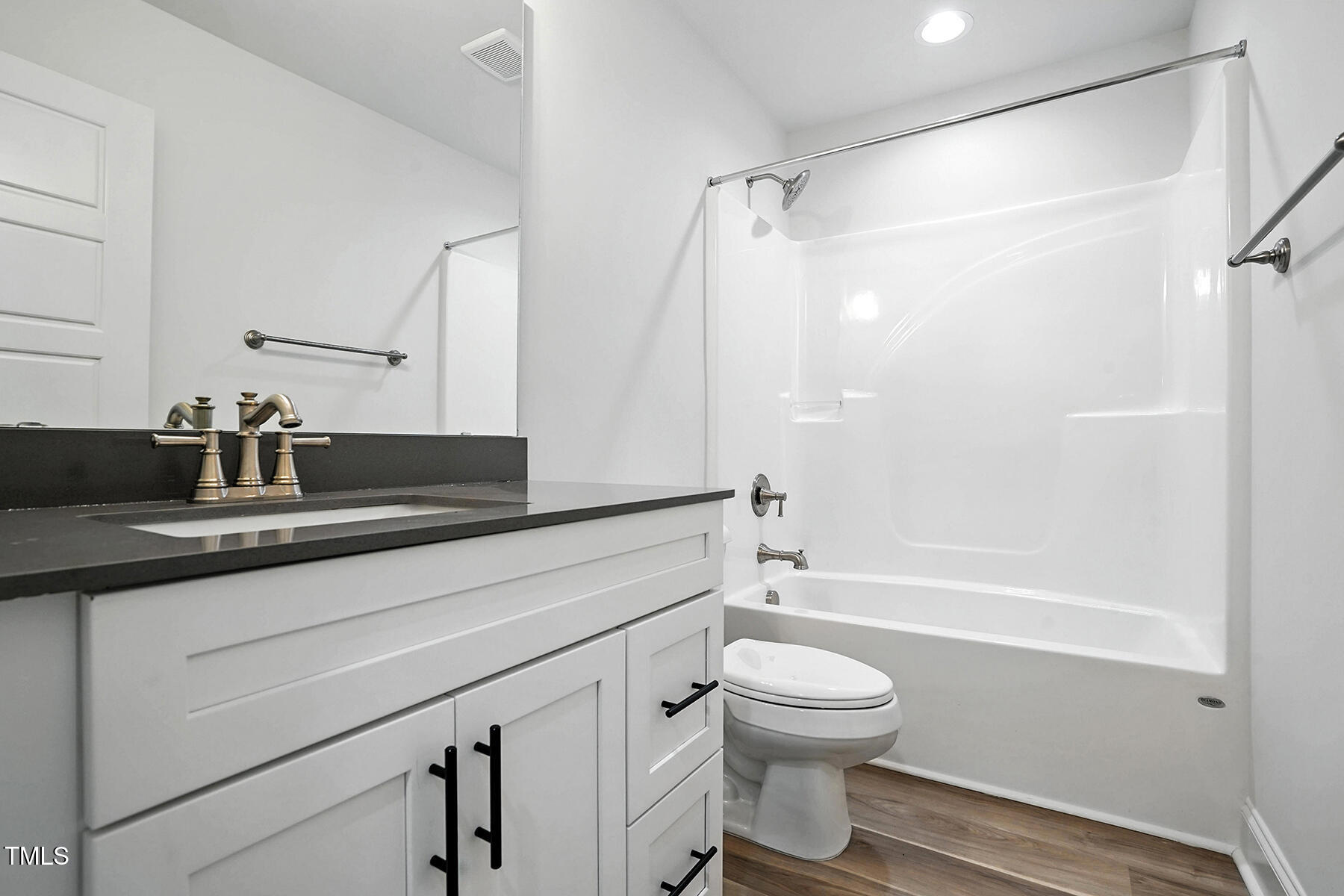 8670 Green Path Road Dunn, NC 28334 - Photo 14 of 34 a bathroom with a granite countertop sink toilet a shower and a mirror