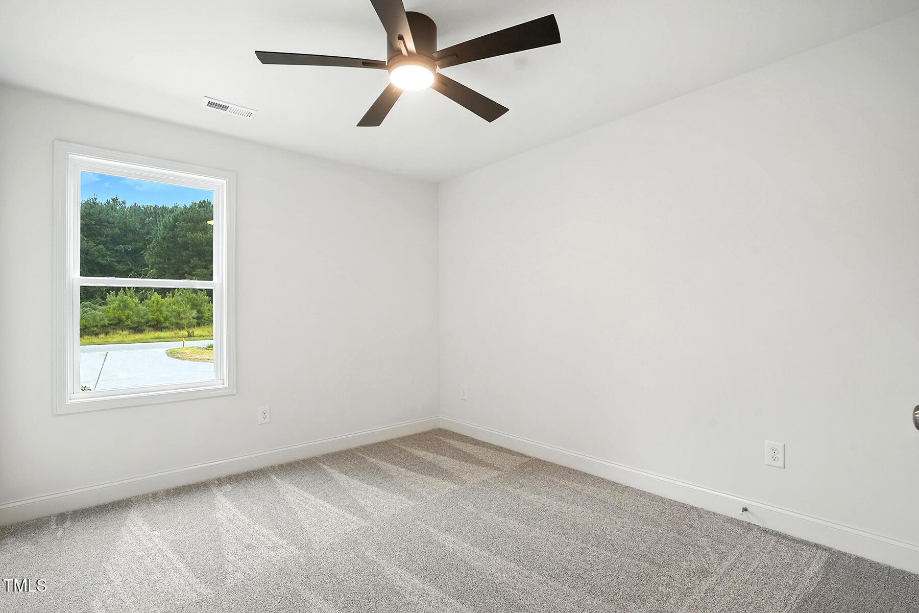 8670 Green Path Road Dunn, NC 28334 - Photo 15 of 34 an empty room with a window and a fan
