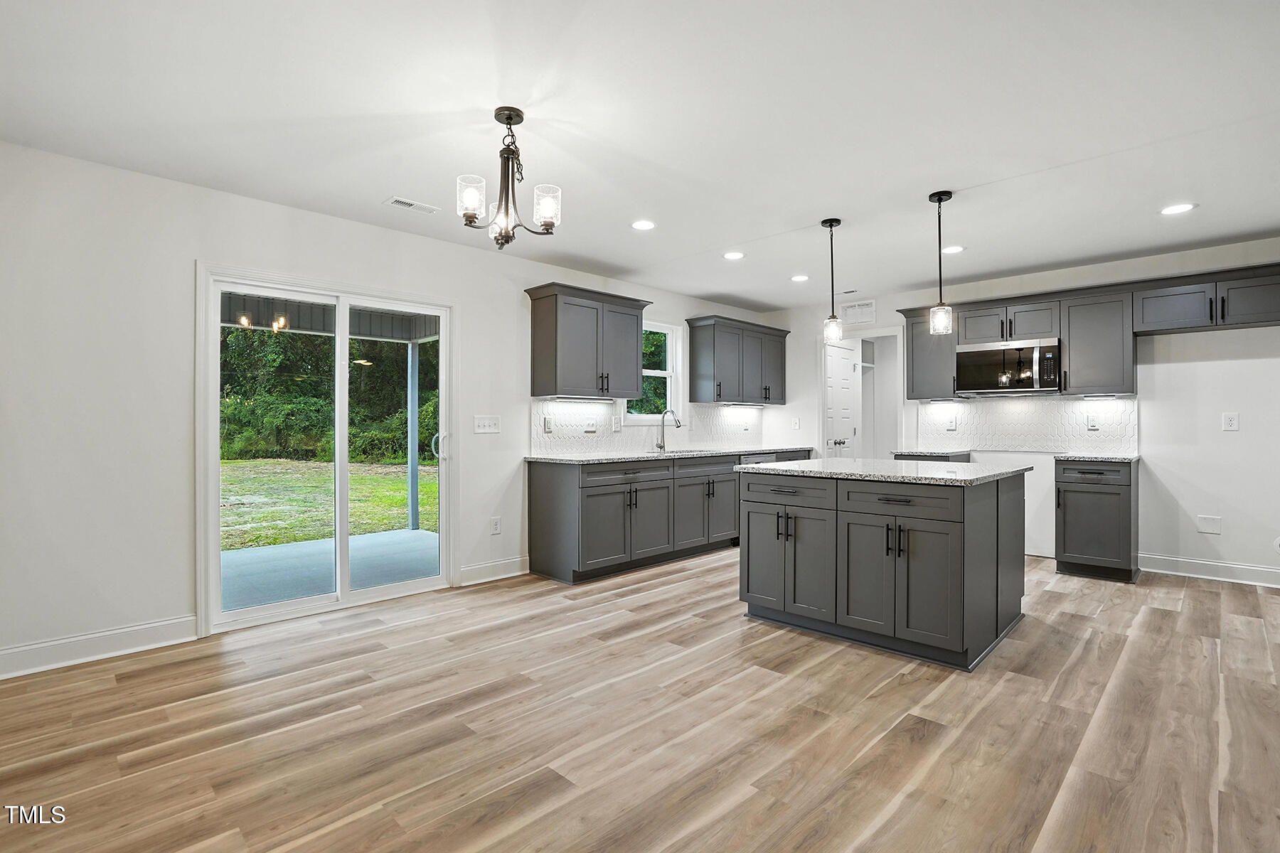 8670 Green Path Road Dunn, NC 28334 - Photo 19 of 34 a large kitchen with kitchen island a sink stainless steel appliances and cabinets