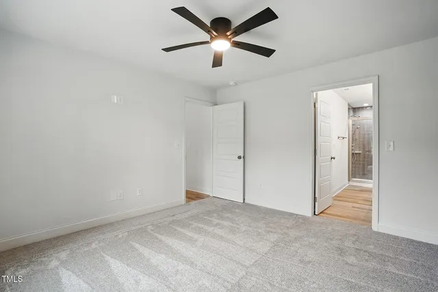 a view of a big room with a ceiling fan