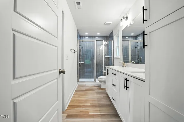 a bathroom with a double vanity sink and mirror