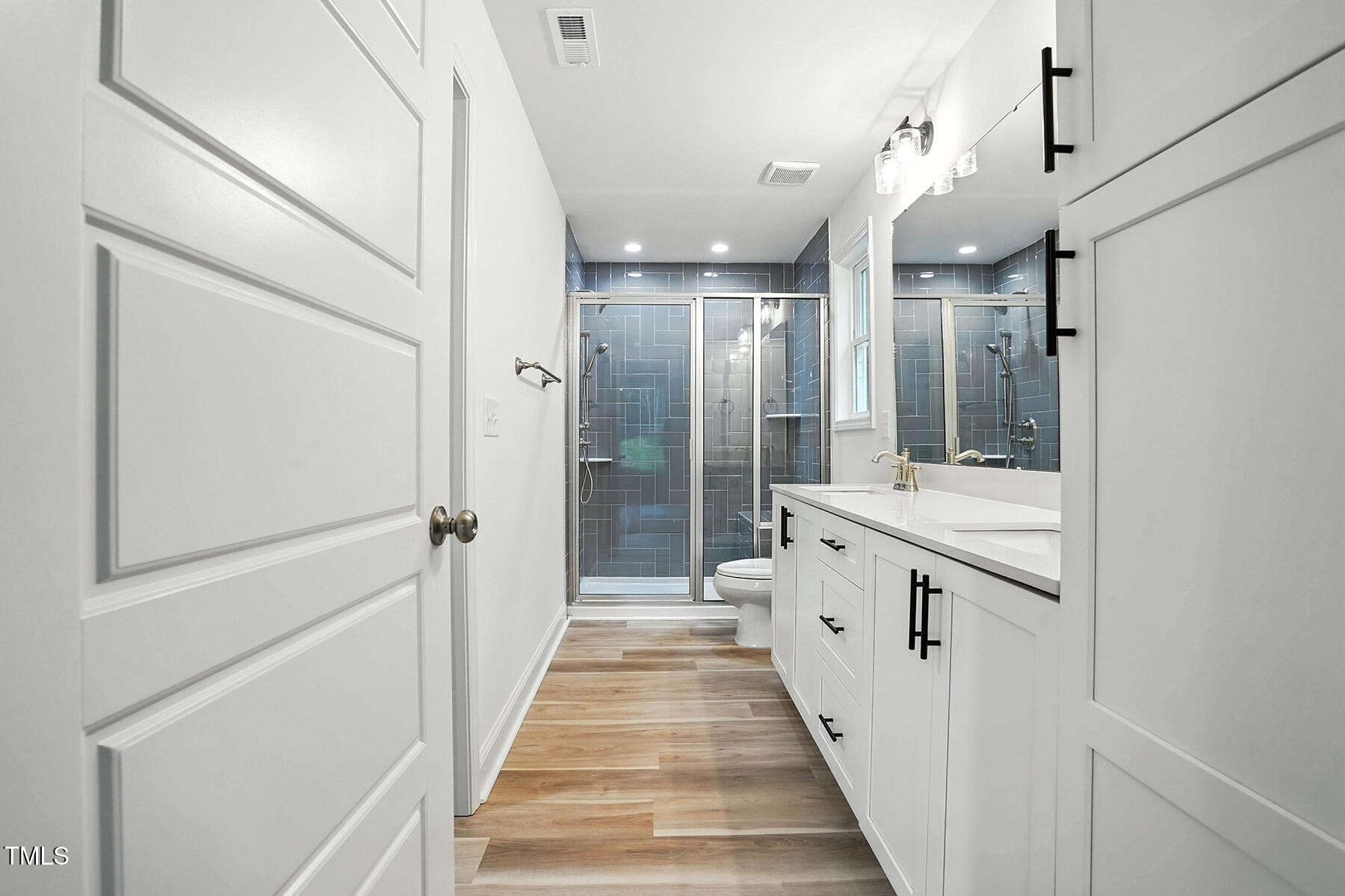 8670 Green Path Road Dunn, NC 28334 - Photo 24 of 34 a bathroom with a double vanity sink and mirror