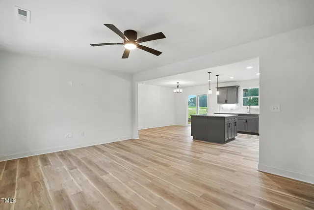 a view of kitchen with sink and wooden floor