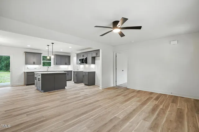 a large white kitchen with a large window