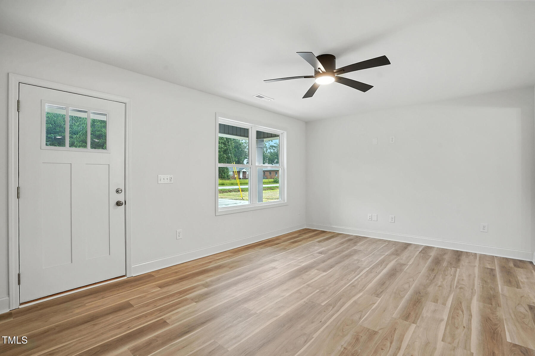 8670 Green Path Road Dunn, NC 28334 - Photo 7 of 34 a view of empty room with wooden floor and fan