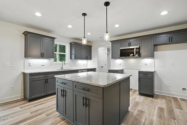 a kitchen with a sink stove and refrigerator