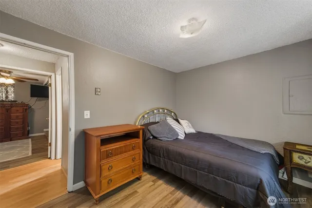 a bedroom with a bed and wooden floor