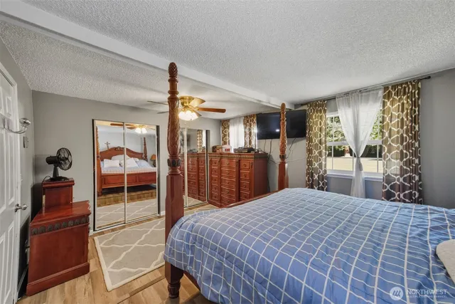 a bedroom with a large bed and a chandelier