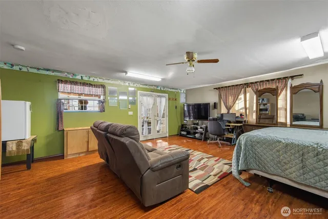 a living room with furniture and a wooden floor