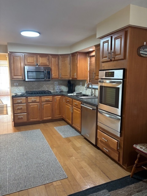 5131 Latrobe Avenue Chicago, IL 60638 - Photo 12 of 23 a kitchen with stainless steel appliances granite countertop a stove a sink and a microwave