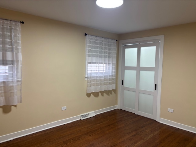 5131 Latrobe Avenue Chicago, IL 60638 - Photo 6 of 23 a view of an empty room with wooden floor and a window