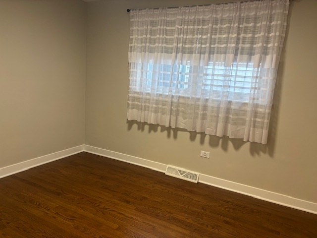 5131 Latrobe Avenue Chicago, IL 60638 - Photo 7 of 23 an empty room with wooden floor and windows