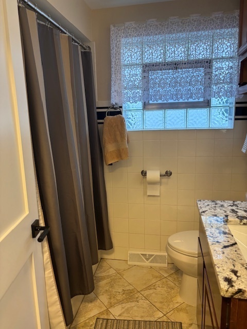 5131 Latrobe Avenue Chicago, IL 60638 - Photo 9 of 23 a bathroom with a sink a toilet a window and vanity