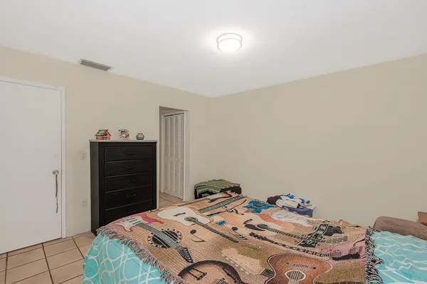 a bedroom with a bed and a dresser