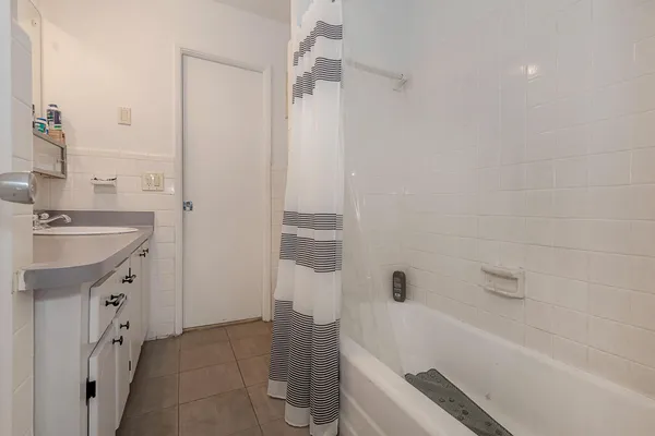 a bathroom with a bathtub a sink a vanity and a shower