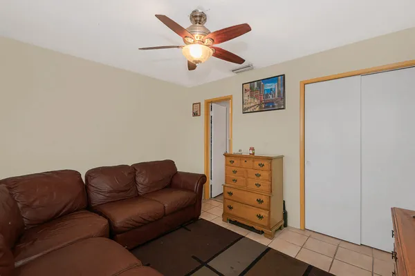 a living room with furniture and ceiling fan