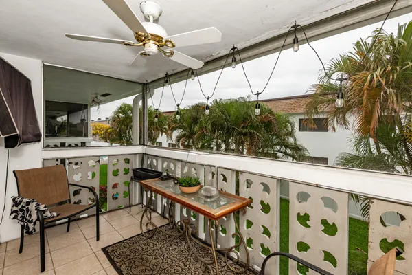 a balcony with furniture and a potted plant