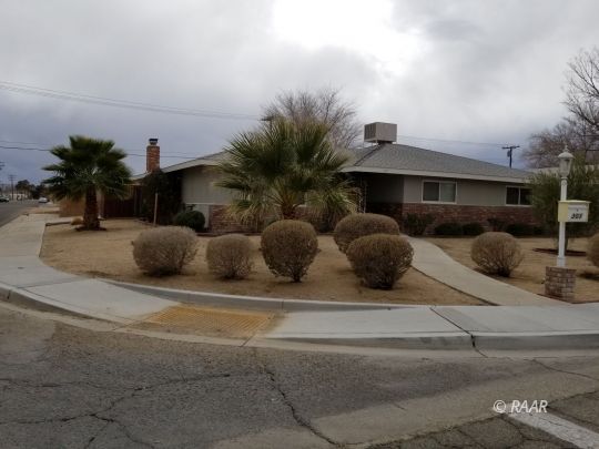 301 West Perdew Avenue Ridgecrest, CA 93555 - Photo 1 of 17 a couple of cars parked in front of a house