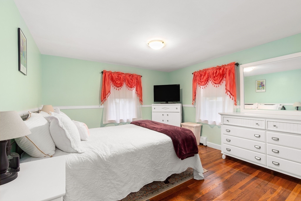 22 Baker Street Brockton, MA 02302 - Photo 14 of 32 a bedroom with a bed and a flat screen tv