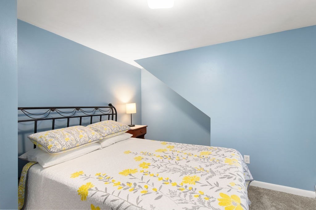 22 Baker Street Brockton, MA 02302 - Photo 18 of 32 a bed sitting in a bedroom and lamp
