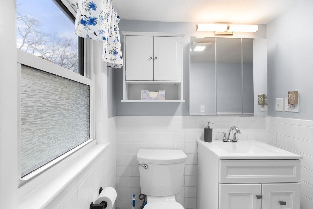 22 Baker Street Brockton, MA 02302 - Photo 22 of 32 a bathroom with a sink a toilet and shower