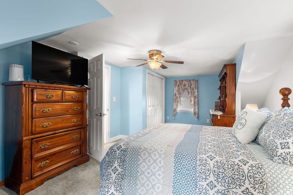 22 Baker Street Brockton, MA 02302 - Photo 24 of 32 a bedroom with a bed and a television