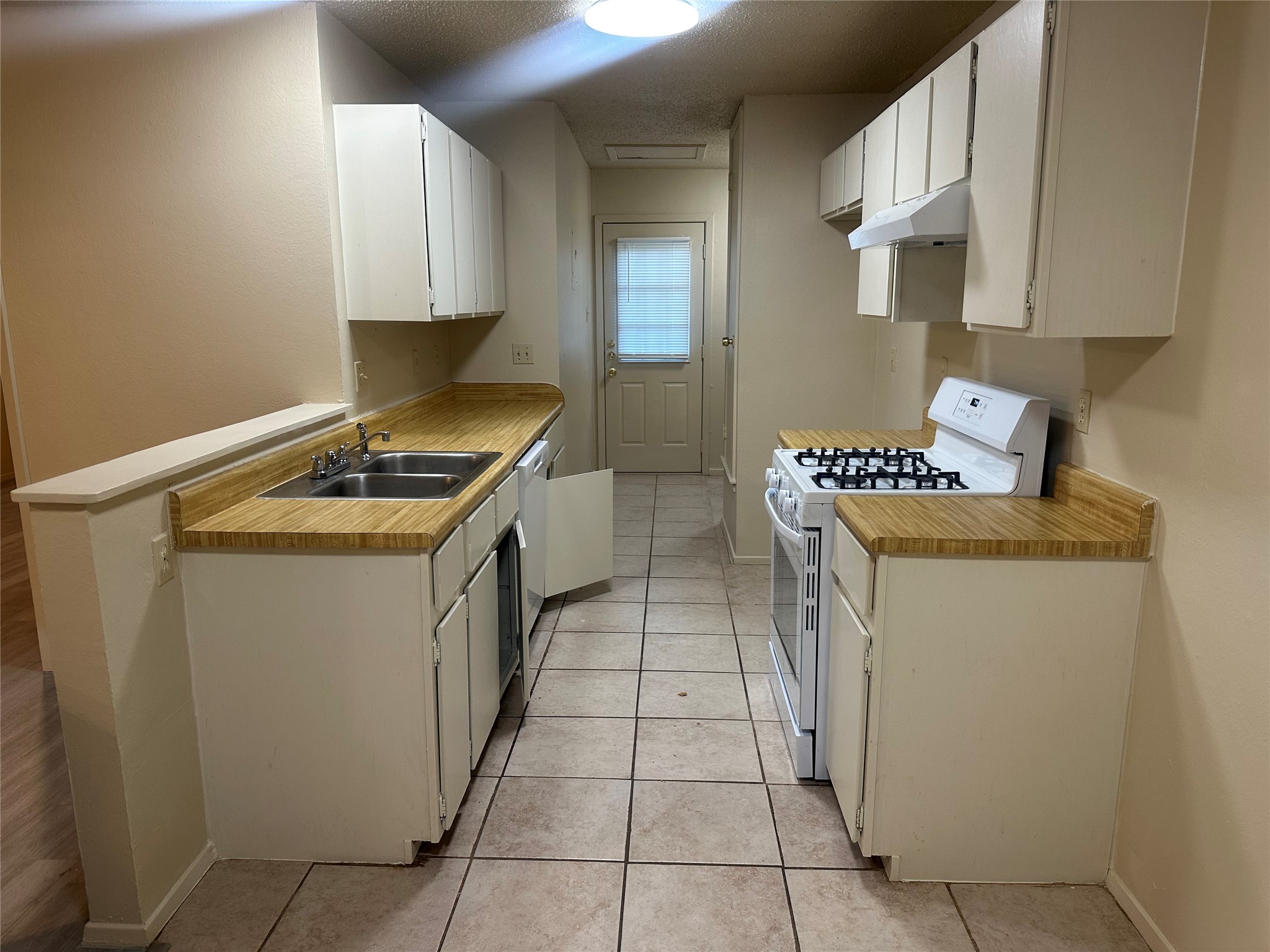 2602 South Bagdad Road, Unit A Leander, TX 78641 - Photo 18 of 26 Functional kitchen with ample cabinet space, dual sinks, and gas range ready for daily meals.