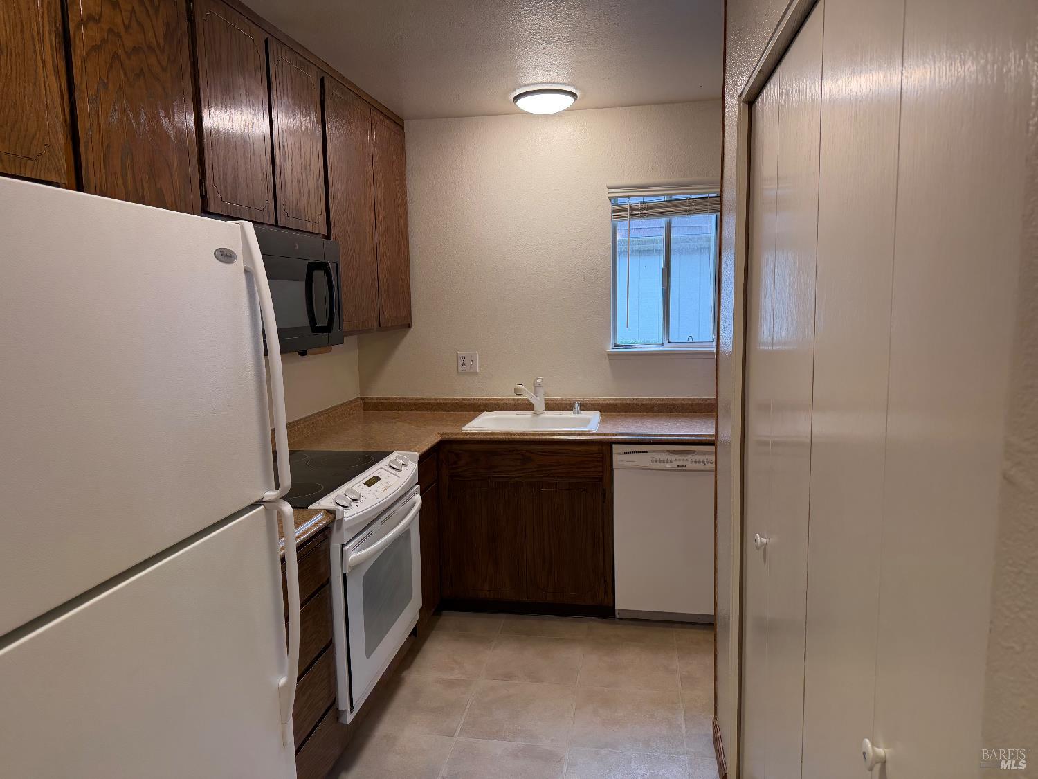 1964 Knolls Drive Santa Rosa, CA 95405 - Photo 14 of 39 a kitchen with a refrigerator and a sink