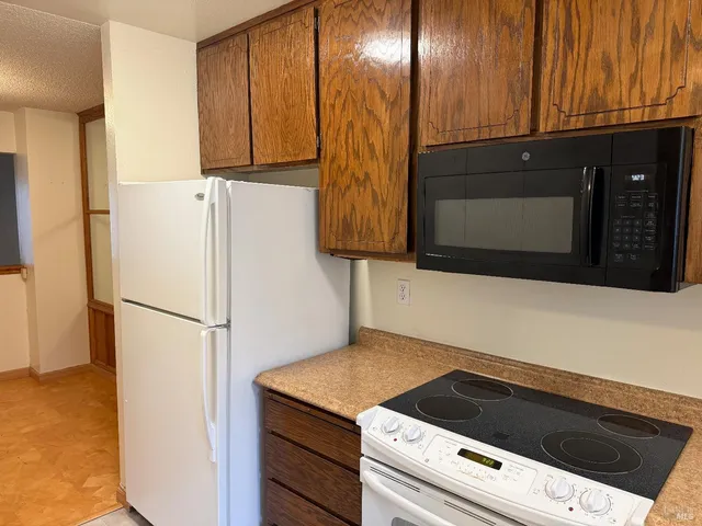 a kitchen with a refrigerator and a microwave