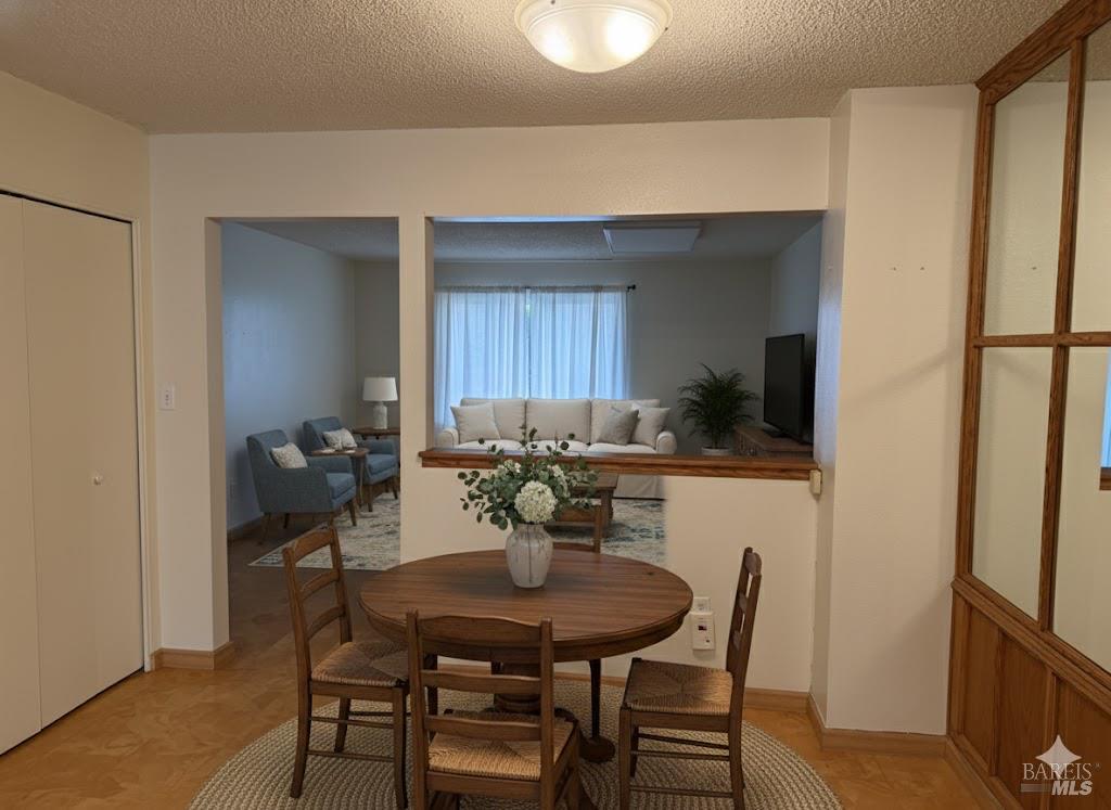 1964 Knolls Drive Santa Rosa, CA 95405 - Photo 8 of 39 a view of a dining room with furniture and a potted plant
