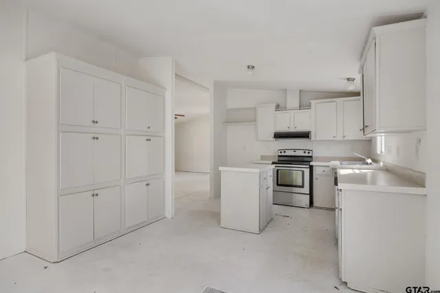 a kitchen with cabinets and appliances