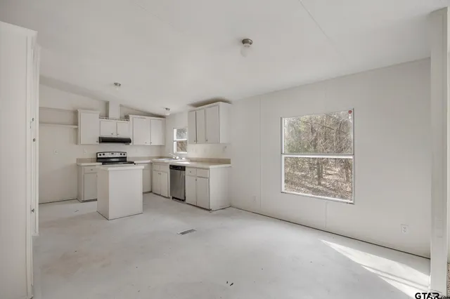 a kitchen with white cabinets and white appliances