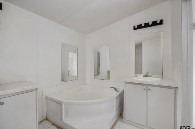 a white bath tub sitting next to a white sink