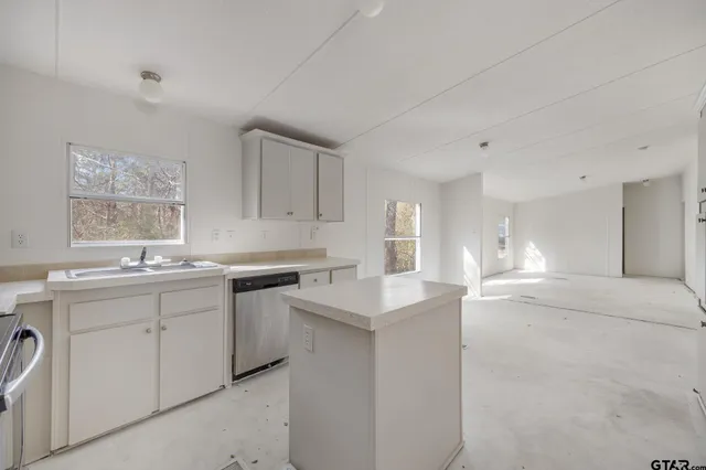 a kitchen with a sink cabinets and window