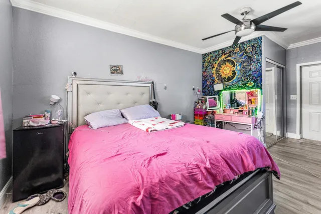 a bed sitting in a bedroom and painting on the wall