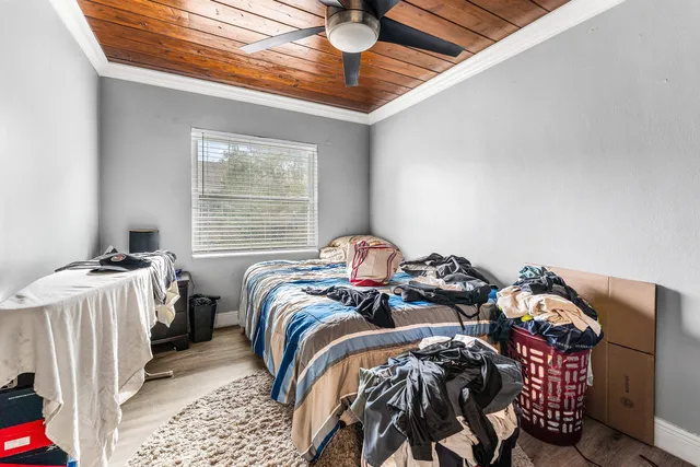 a bedroom with two beds and a window