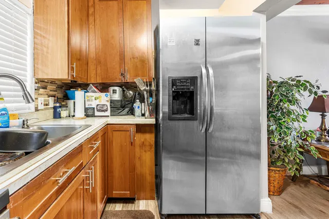 a kitchen with kitchen island a counter top space a sink and refrigerator