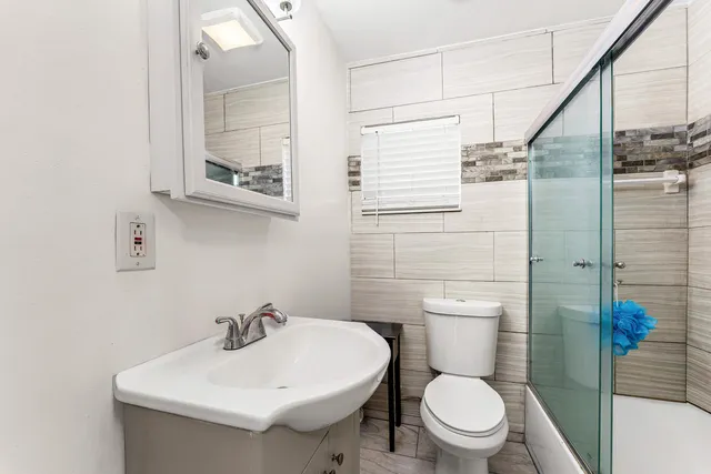 a bathroom with a sink toilet and shower