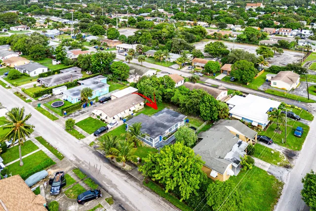 an aerial view of residential houses with outdoor space